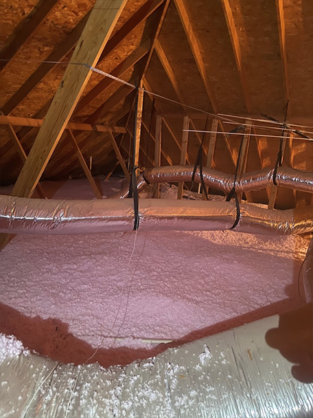 Metal warehouse building insulated with spray foam and batt insulation